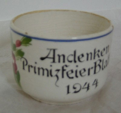Mit Blumen bemalte Henkeltasse aus Keramik mit der Aufschrift "Andenken Primizfeier Blatten 1944". Geschenk Hans-Anton Ebener, Blatten, 2005.